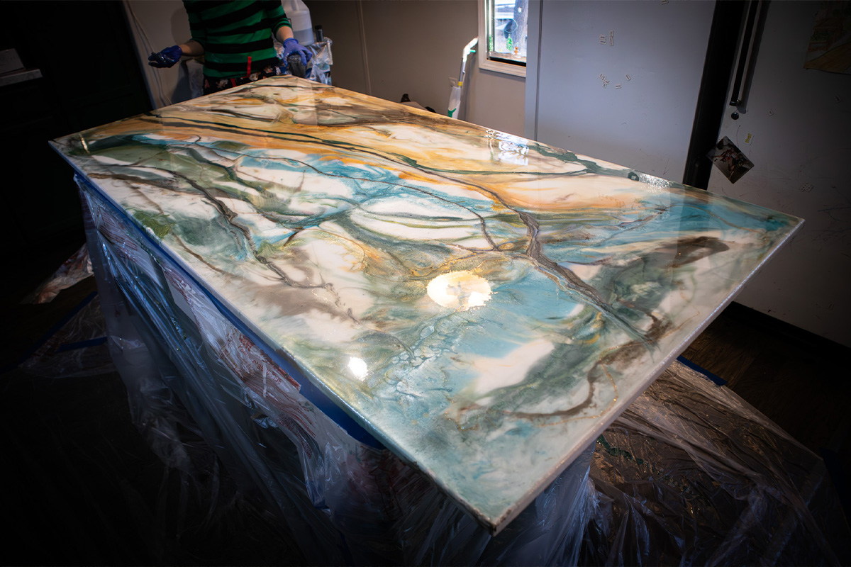 Custom epoxy countertop with marbled blue, white, and gold finish