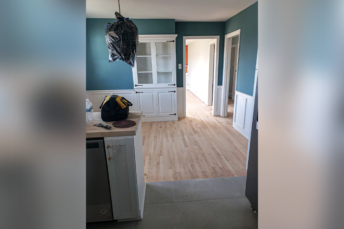 Freshly painted interior room with blue walls, white trim, and built-in cabinetry